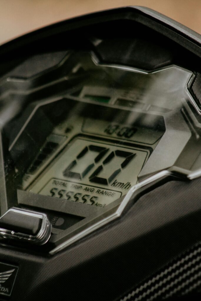 Detailed view of a motorcycle's electronic speedometer displaying speed and distance traveled.